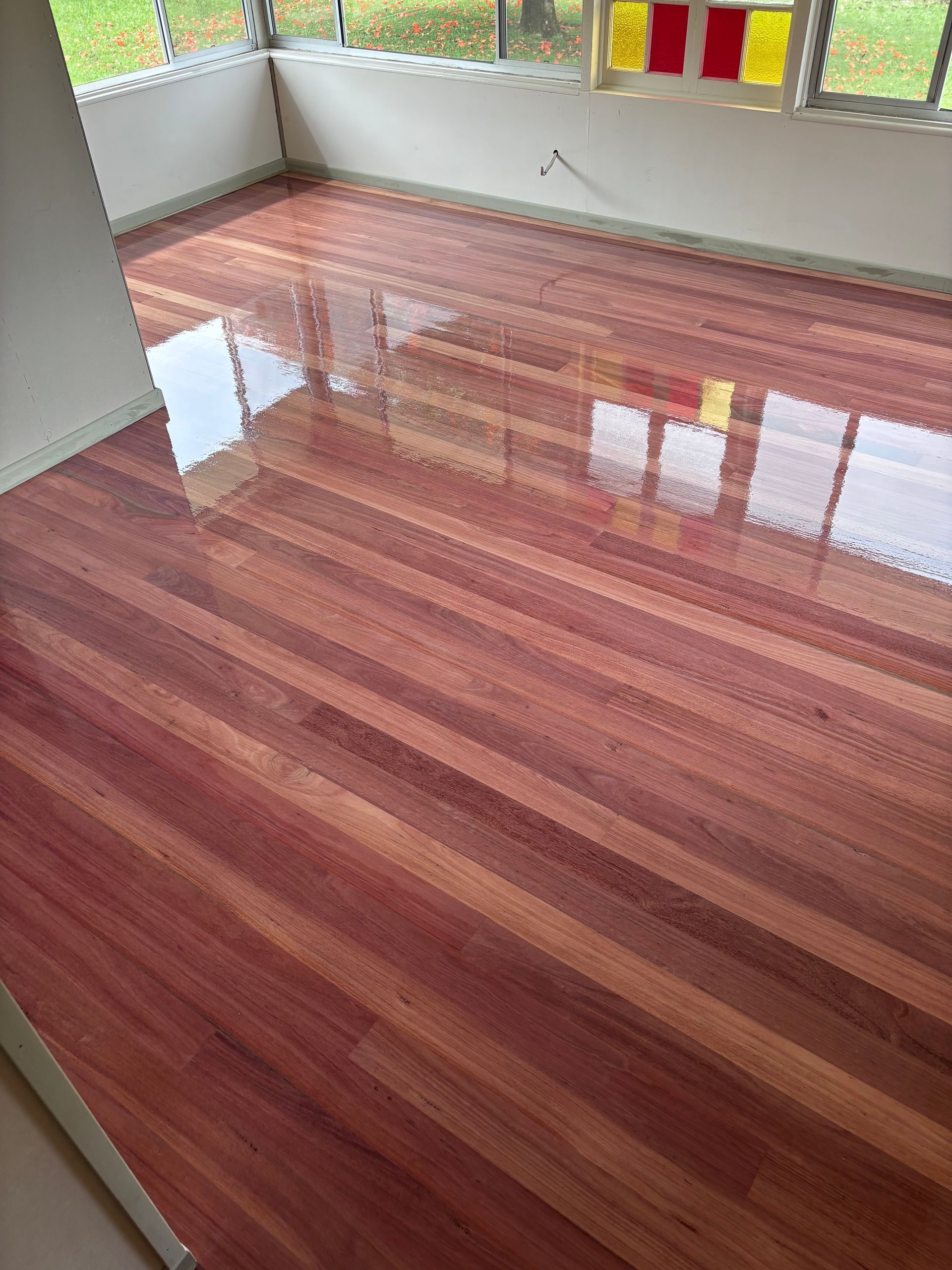 Polished, Reddish-brown Wooden Floor — Scott Johnston Floor Sanding in Bentley Park QLD