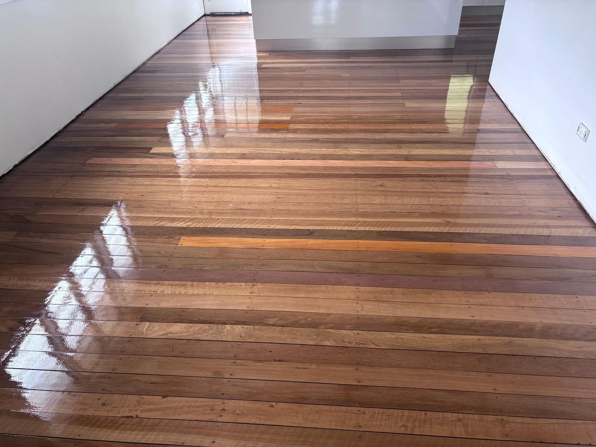 Polished Hardwood Floor With Light Reflections — Scott Johnston Floor Sanding in Bentley Park QLD