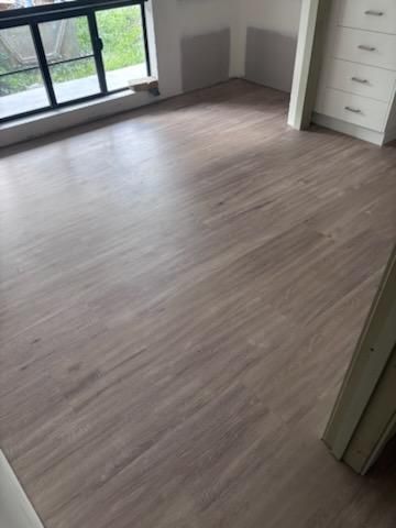 Room With Light Brown Wood-look Flooring — Scott Johnston Floor Sanding in Bentley Park QLD