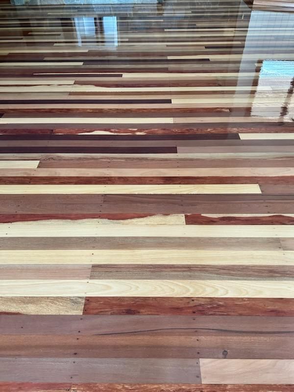Hardwood Floor With Varying Wood Tones Arranged Horizontally — Scott Johnston Floor Sanding in Bentley Park QLD
