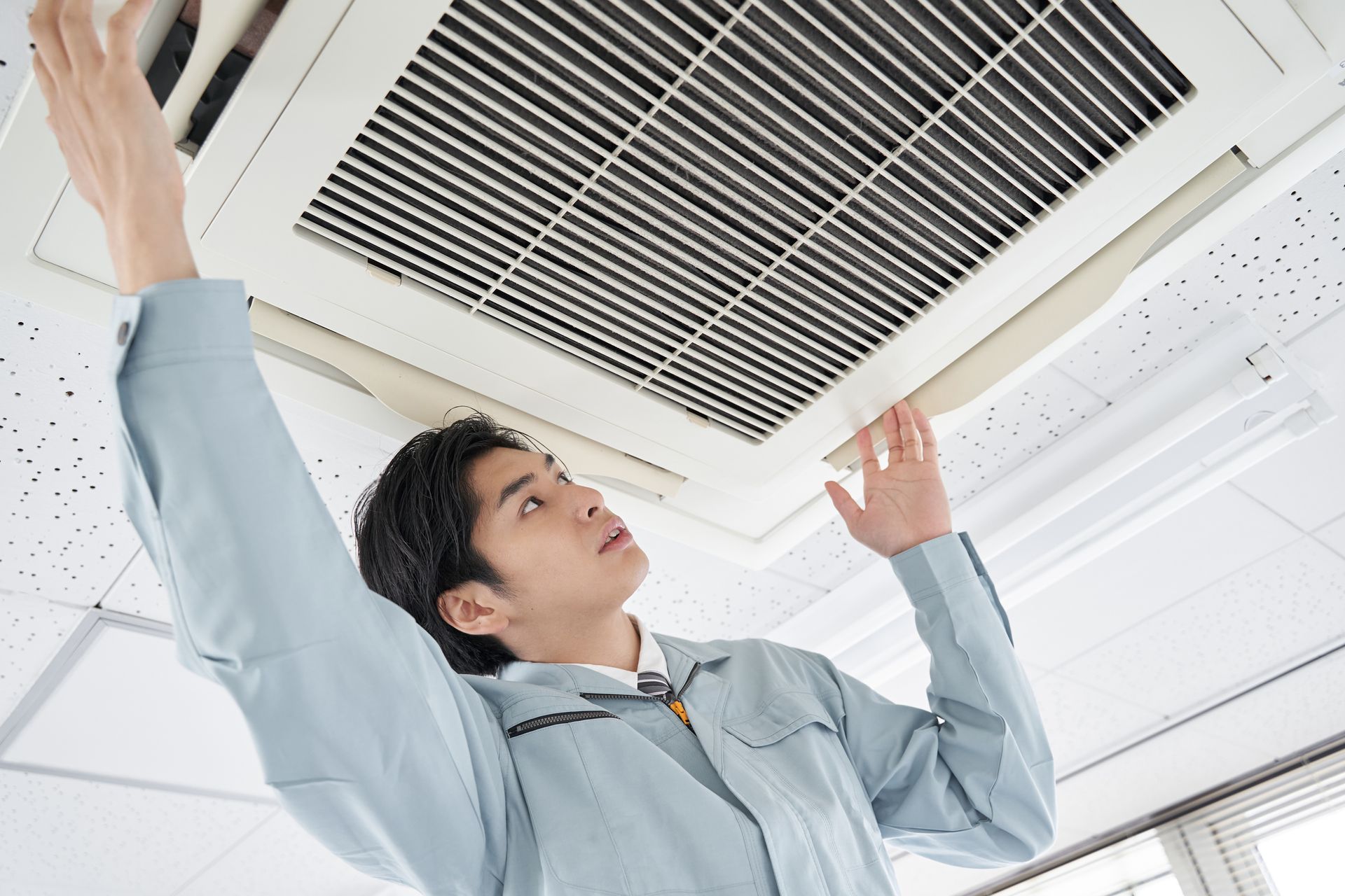 man installing commercial air conditioner