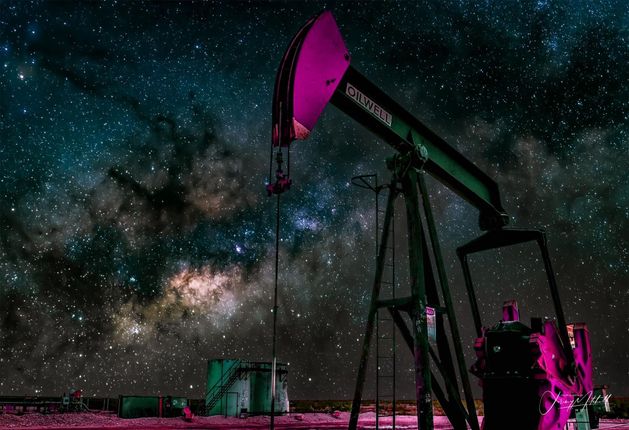 An oil pump with a milky way galaxy in the background