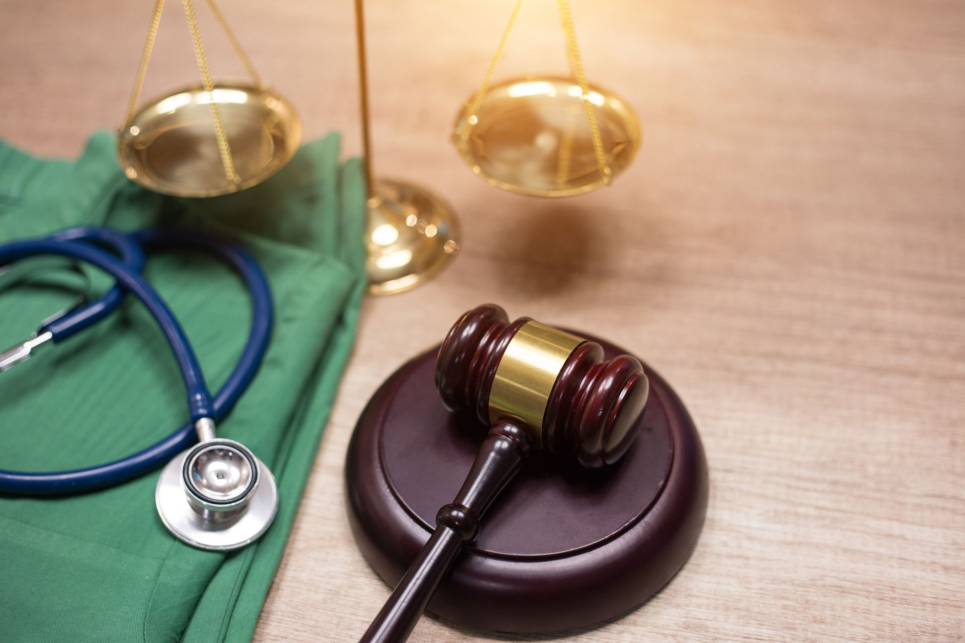 Gavel and stethoscope background with medical laws and legal concepts highlighted.