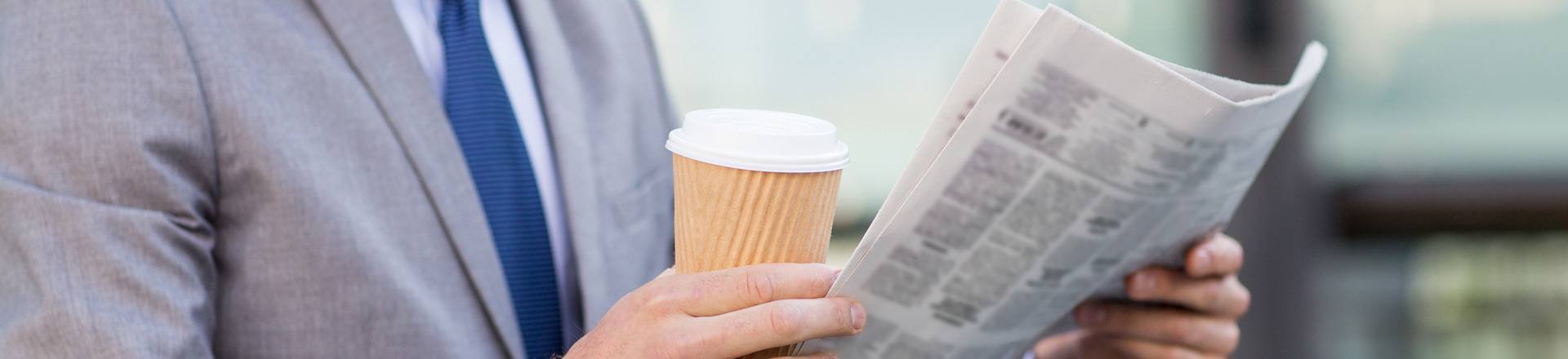 Man Holding A Coffee And Newspaper — Marlton, NJ — Jarve Kaplan Granato Starr, LLC