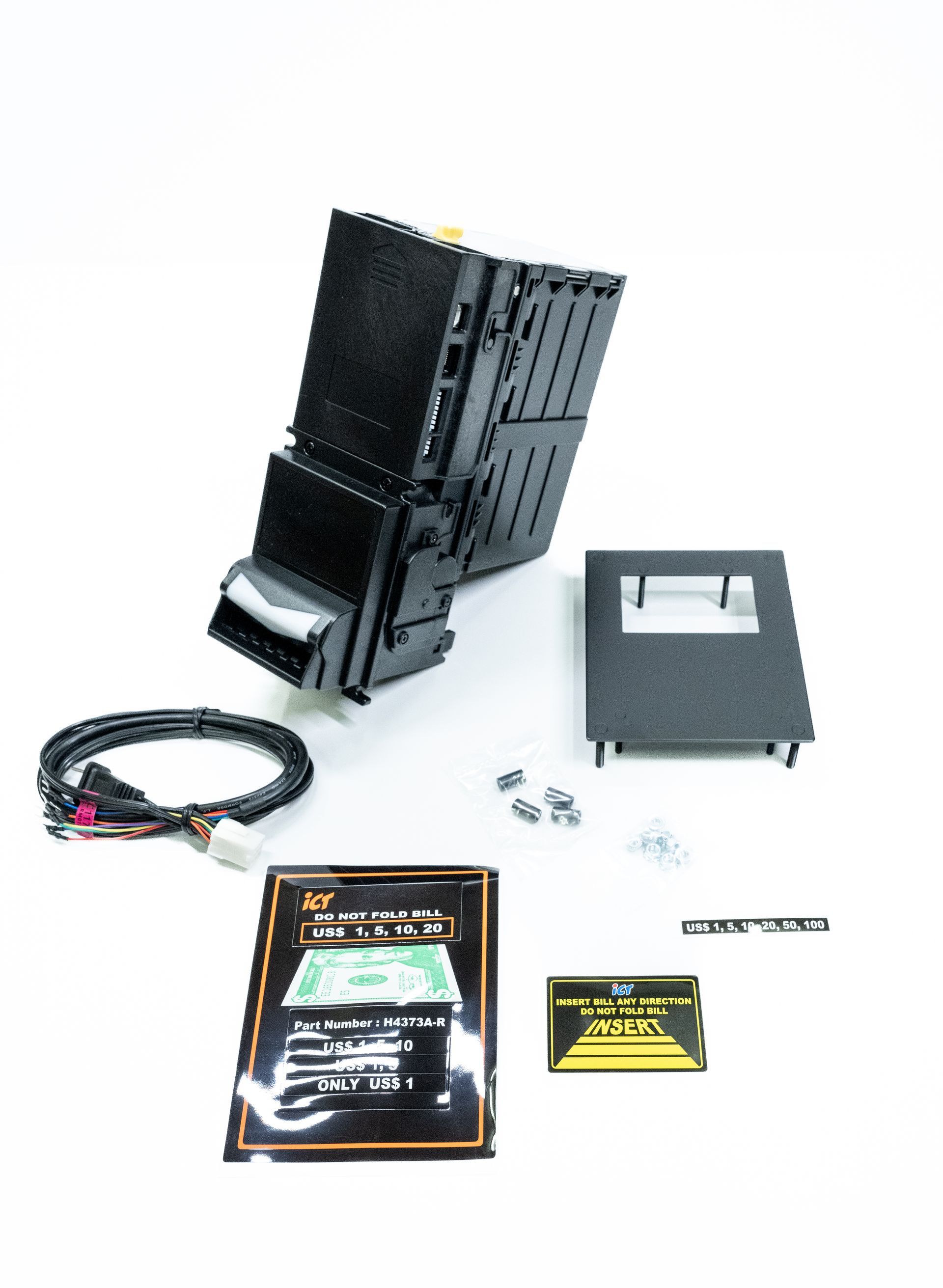 Car audio system components including a black head unit, wiring, and faceplate against a white background.