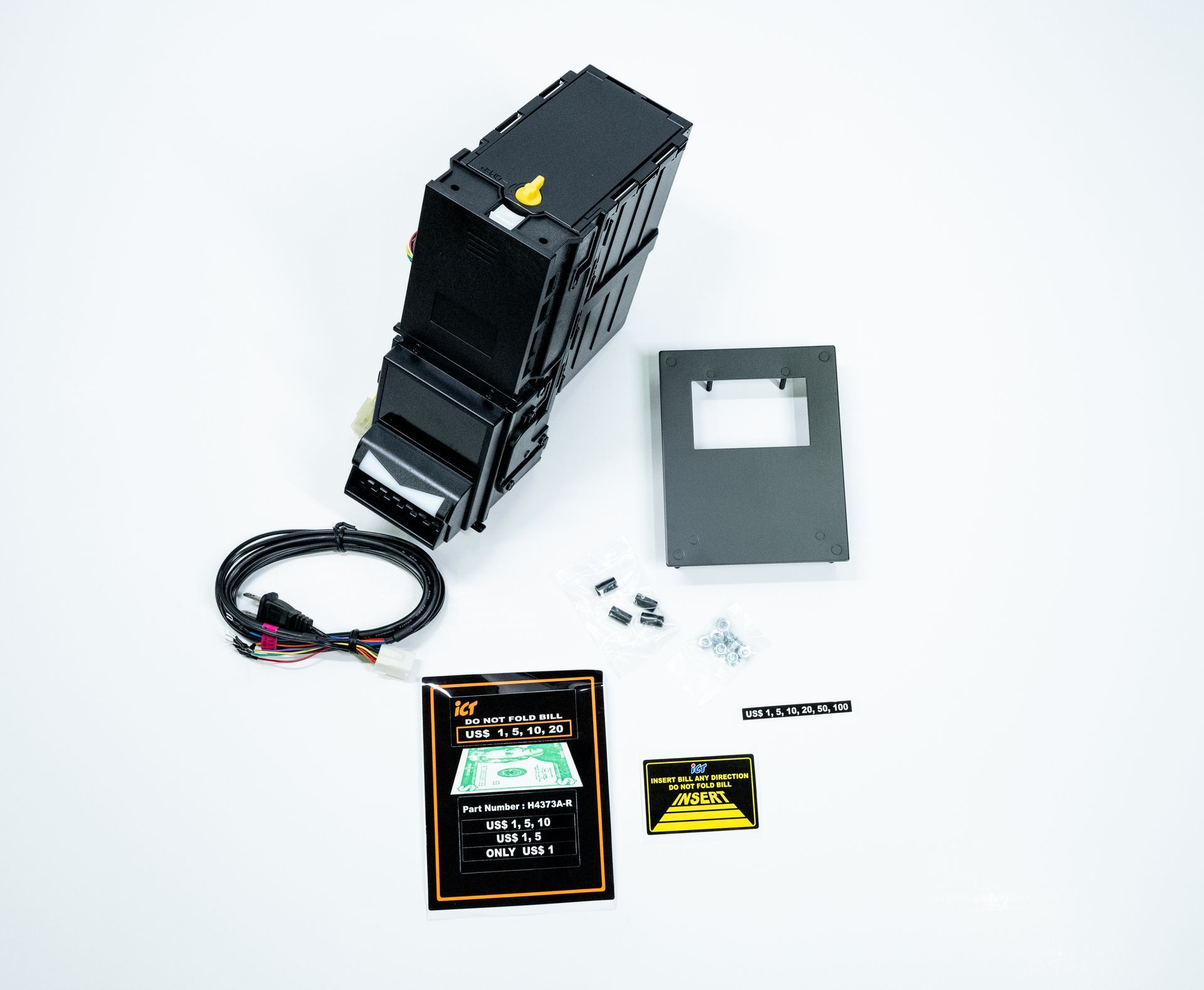 A black automotive component with attached wiring, a cover plate, screws, and two information cards on a white background.