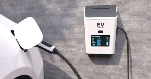An electric car is being charged at a charging station in front of a house.