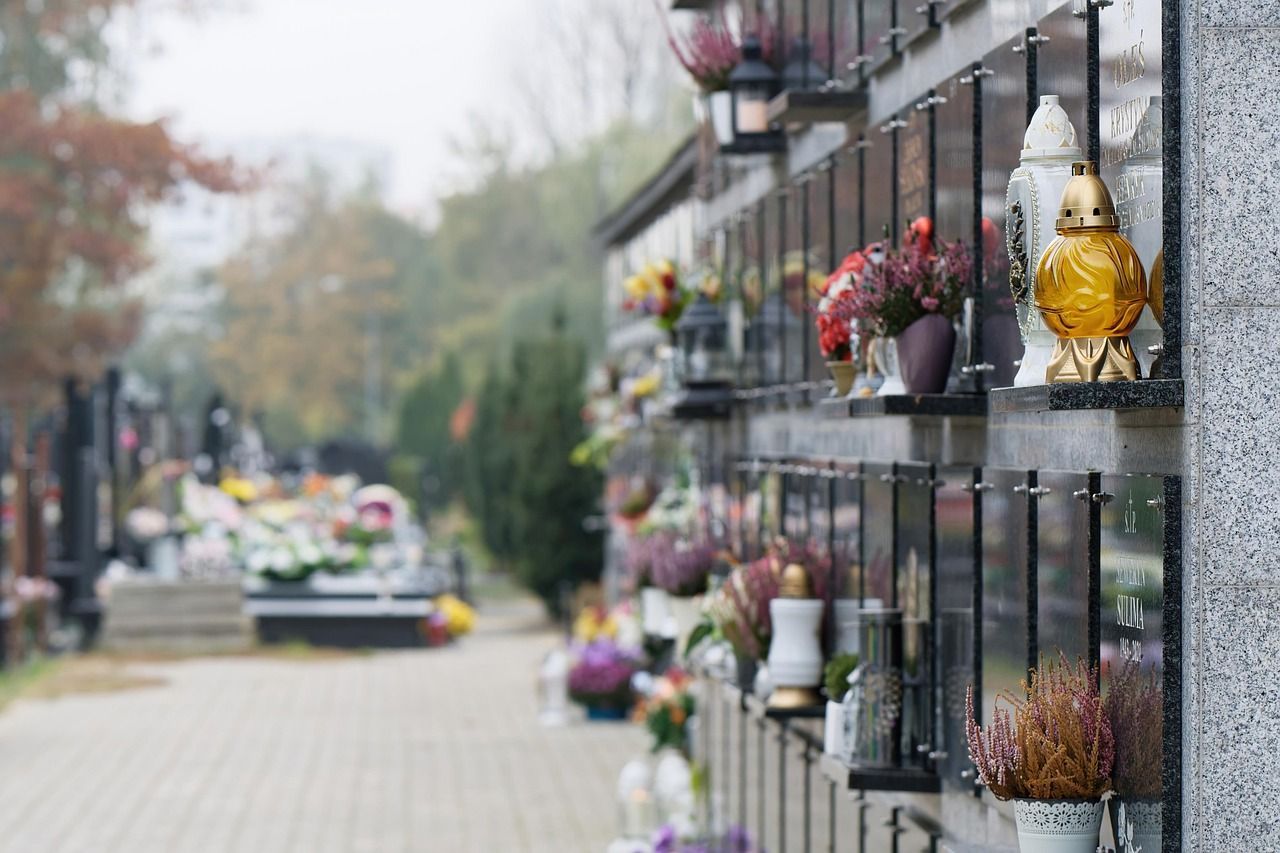 Picture of a vertical cemetery plot, with flowers outside of each one