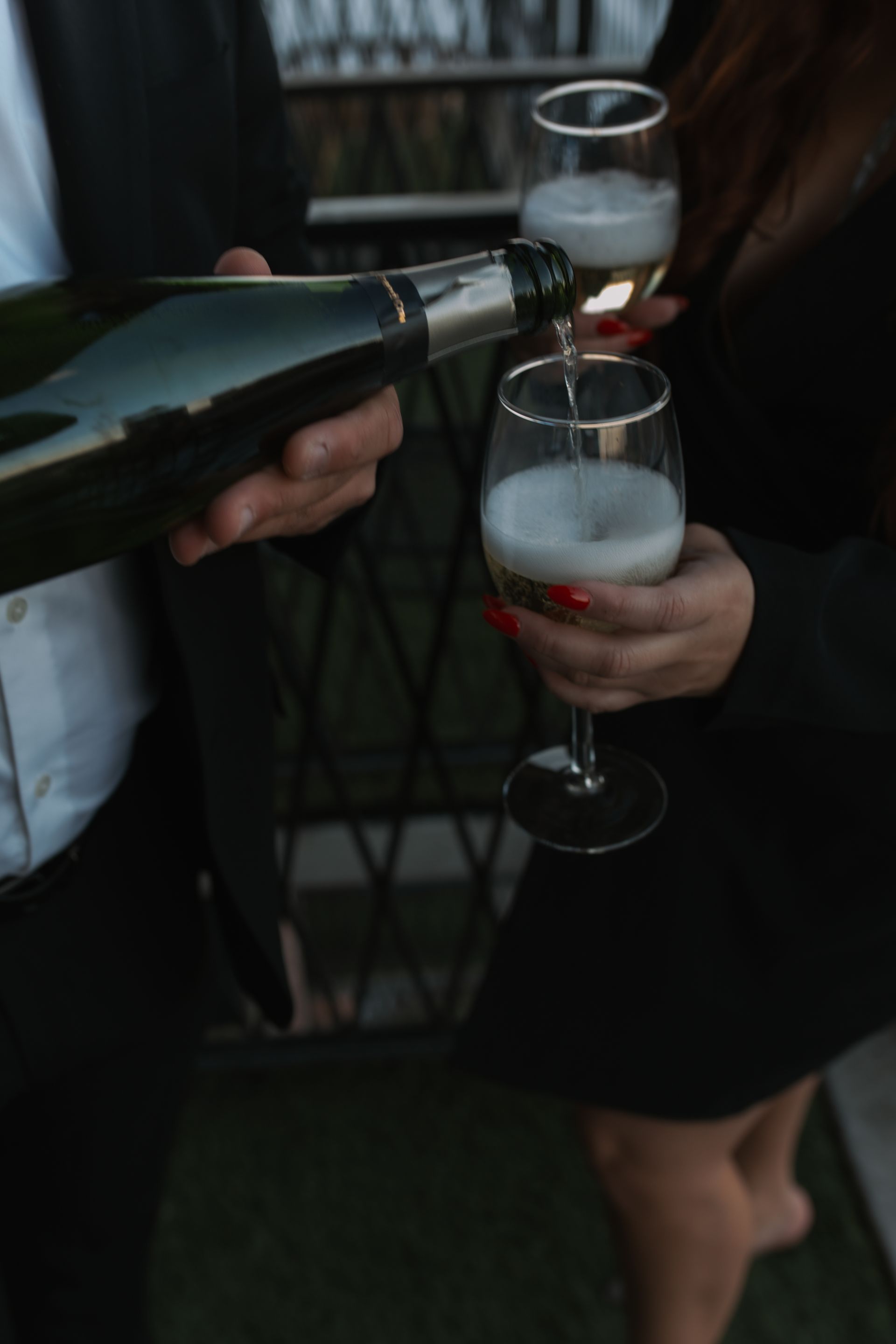 A man is pouring champagne into a woman 's glass.