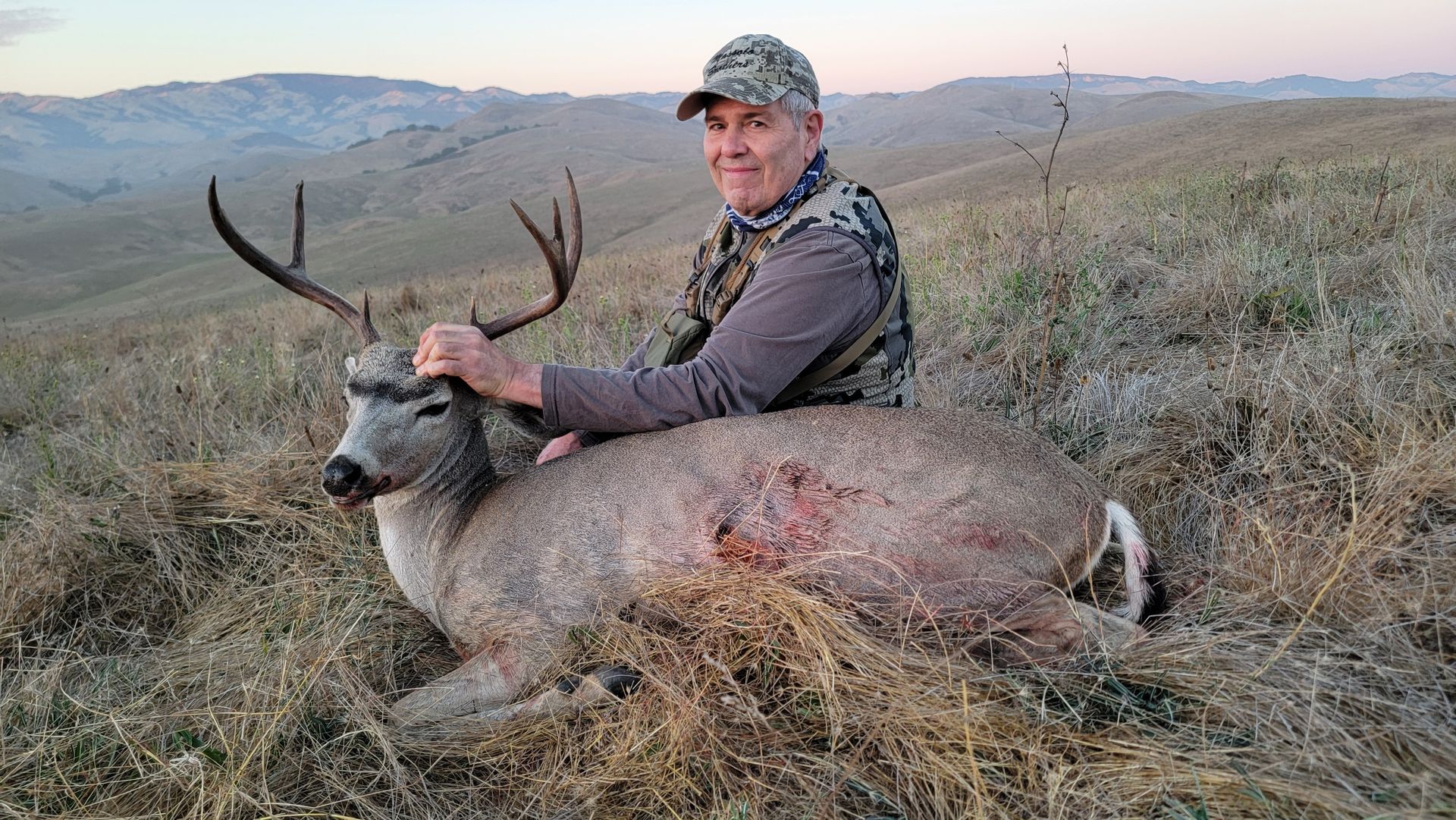 uccessful hunter posing with blacktail during early season hunt