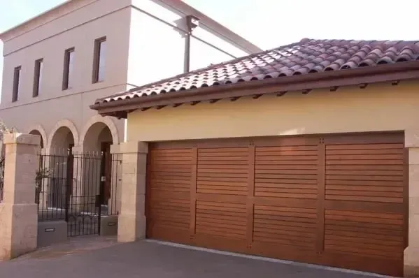 A house with a wooden garage door and a tiled roof