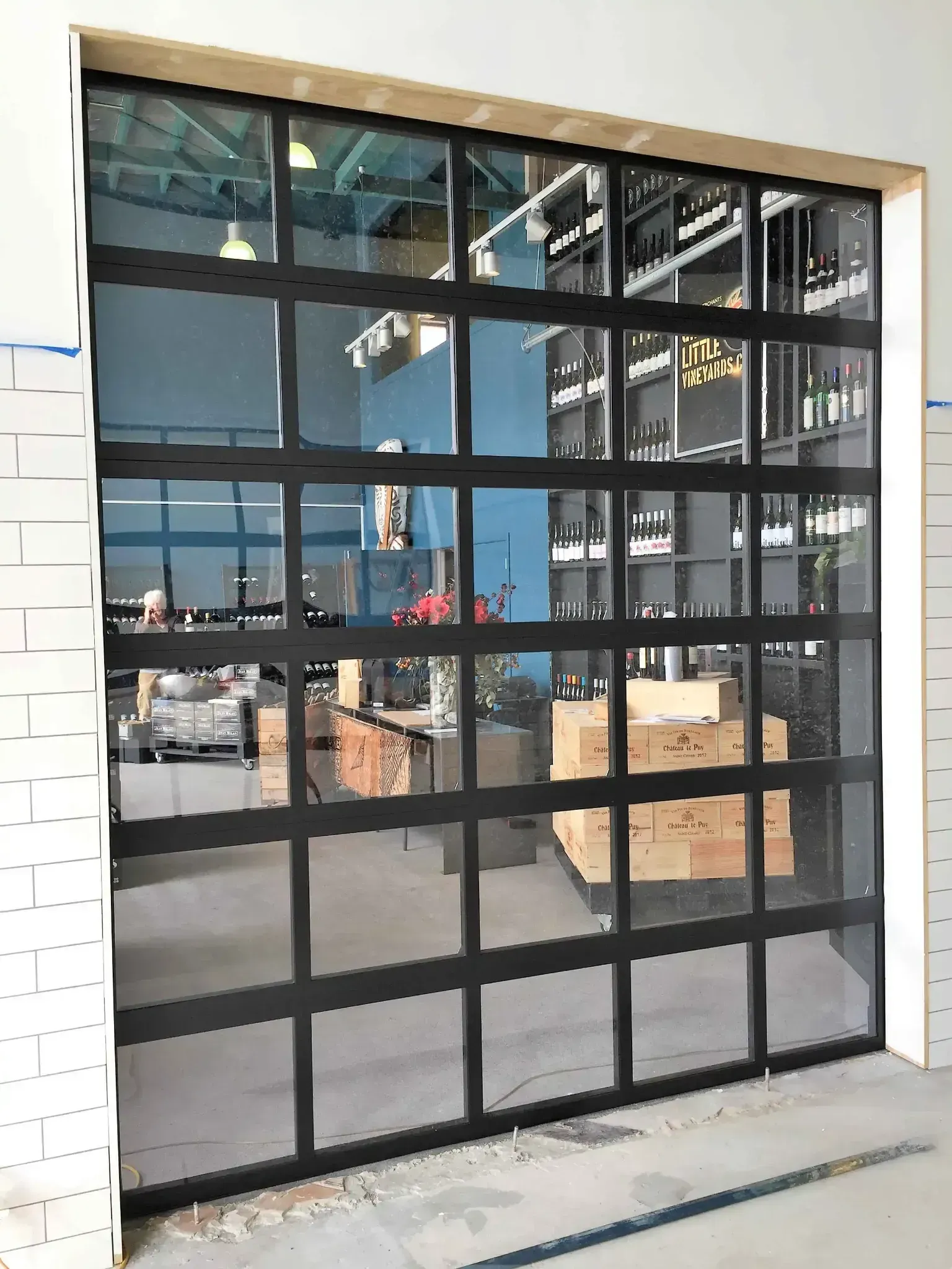 A garage door with a lot of windows in a building.
