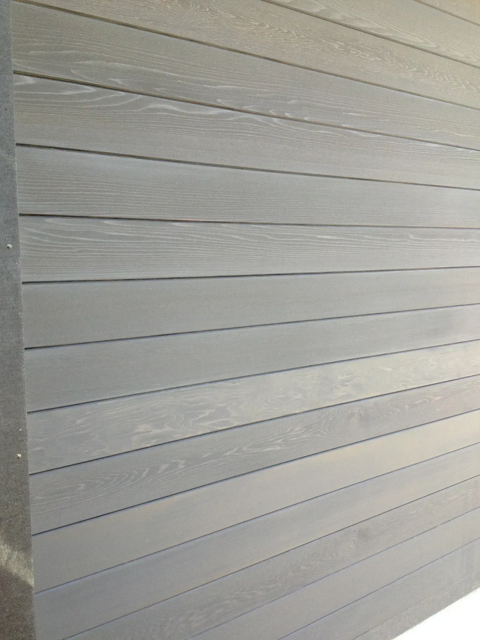 A close-up of a gray garage with a few lines on it