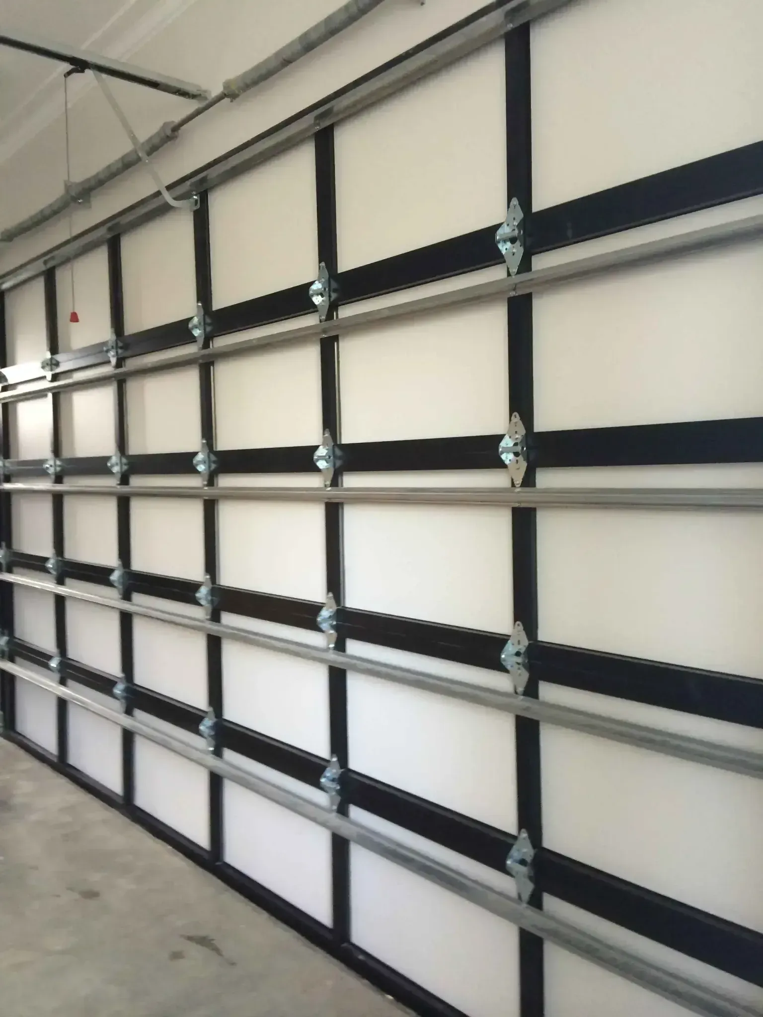 A white garage door with black stripes on it