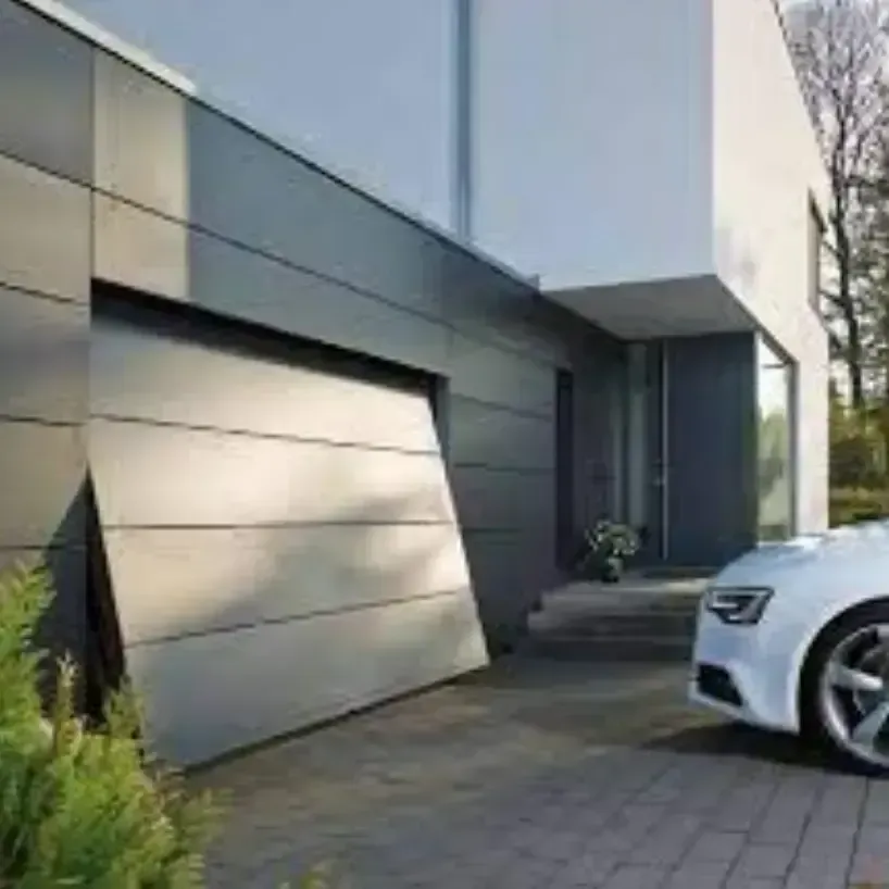 A white car is parked in front of a modern house with a garage door open.