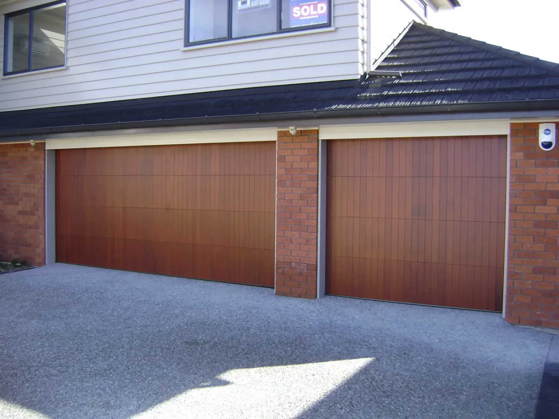 A garage door with a sold sign above it