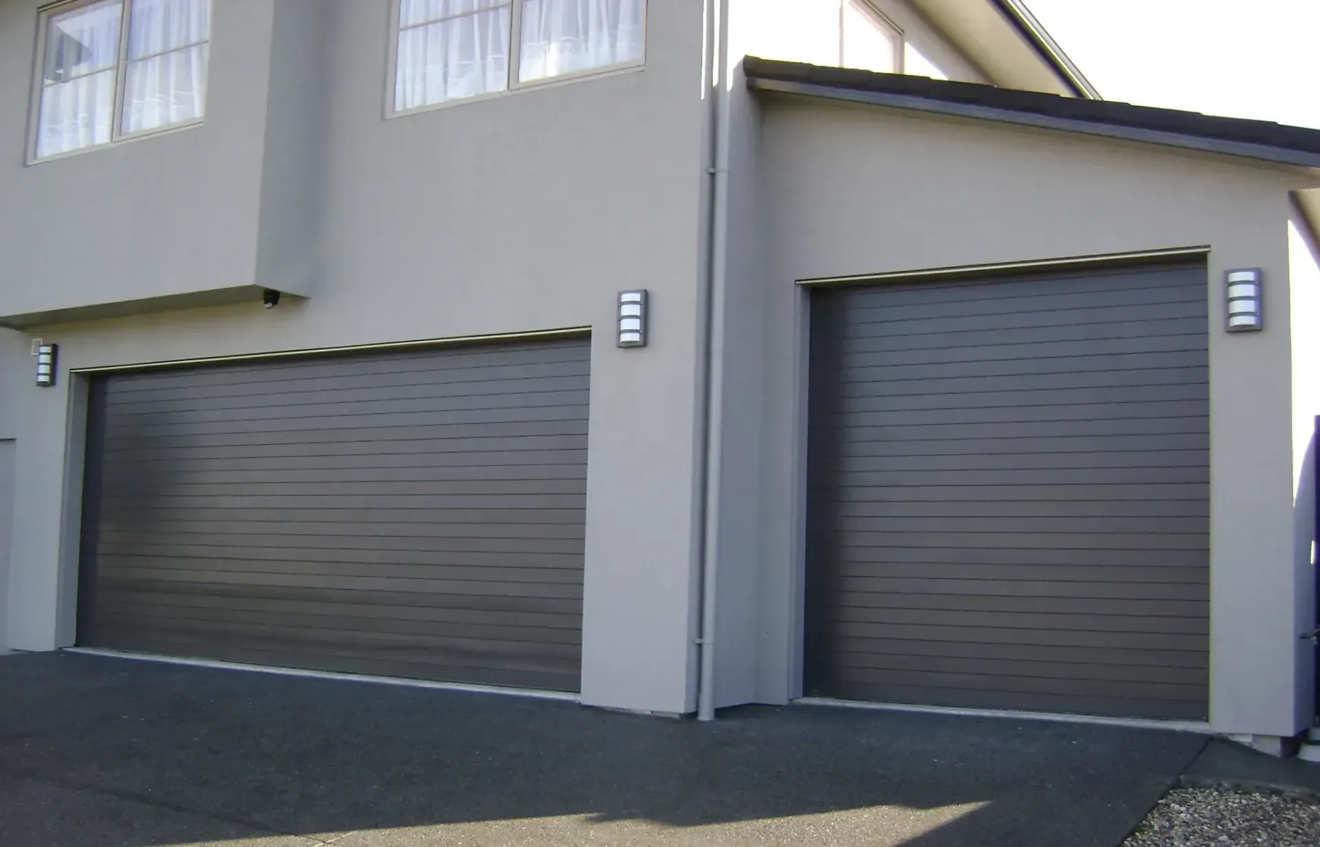 Two garage doors on the side of a house
