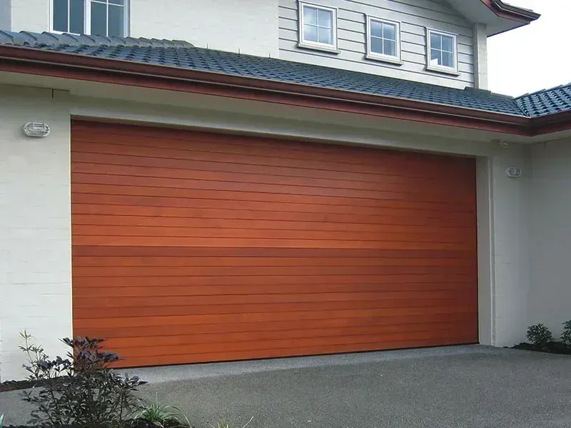 A house with a black roof and a white garage door