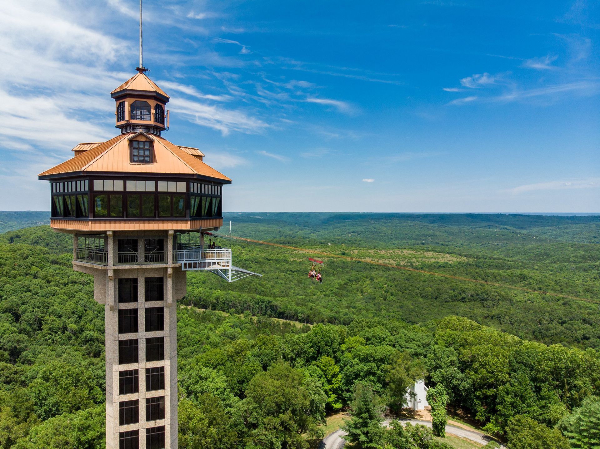 An aerial view of a tower overlooking a forest.