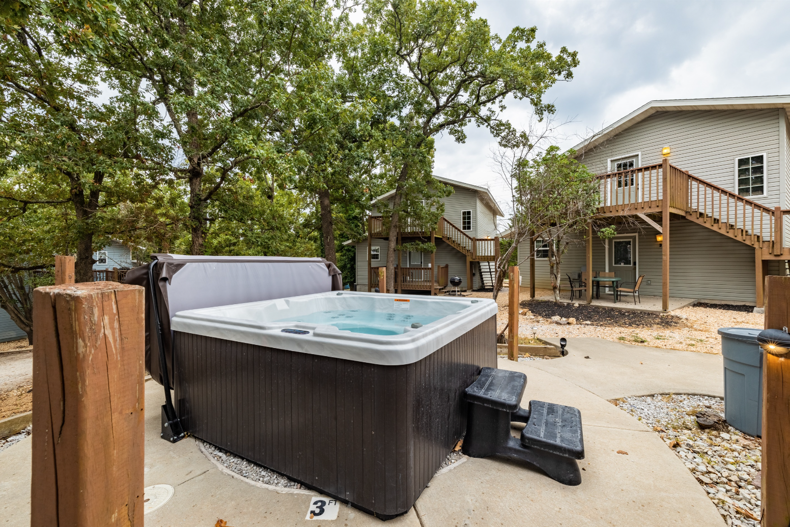 A hot tub is sitting on the sidewalk in front of a house.