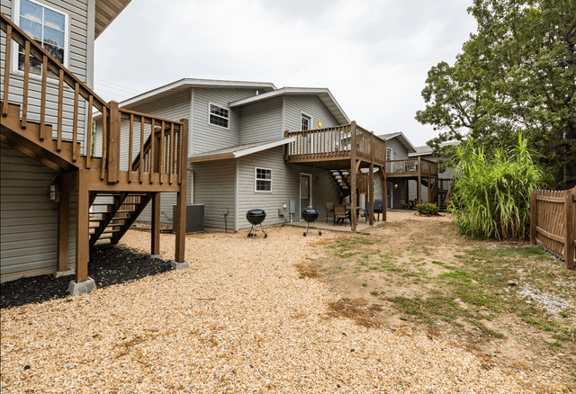 A row of houses with a lot of gravel in front of them.