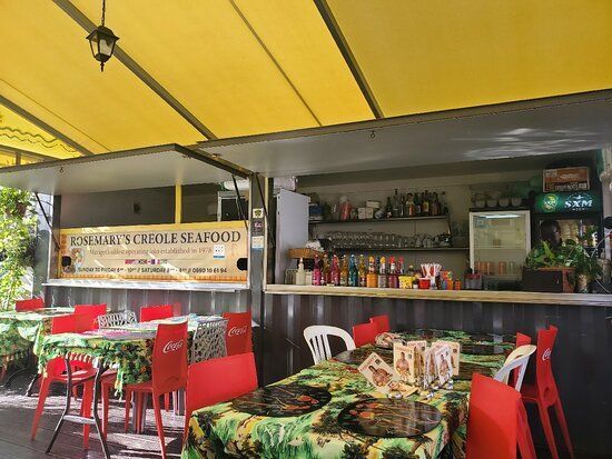 A restaurant with tables and chairs and a sign that says legendary seafood
