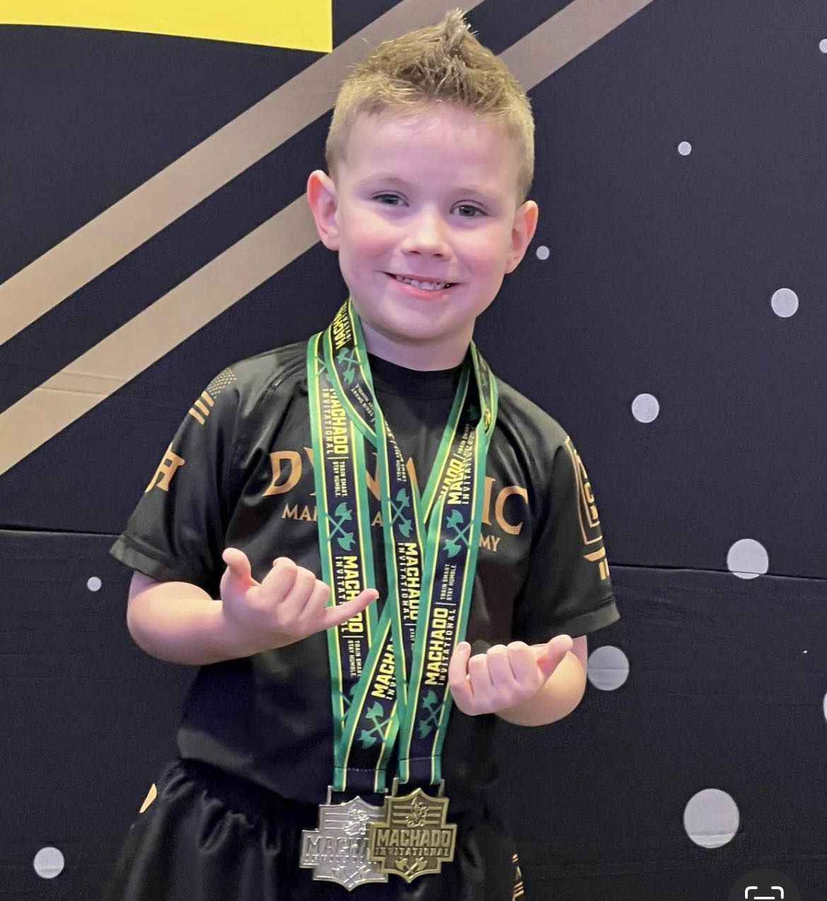 A young boy wearing a medal around his neck