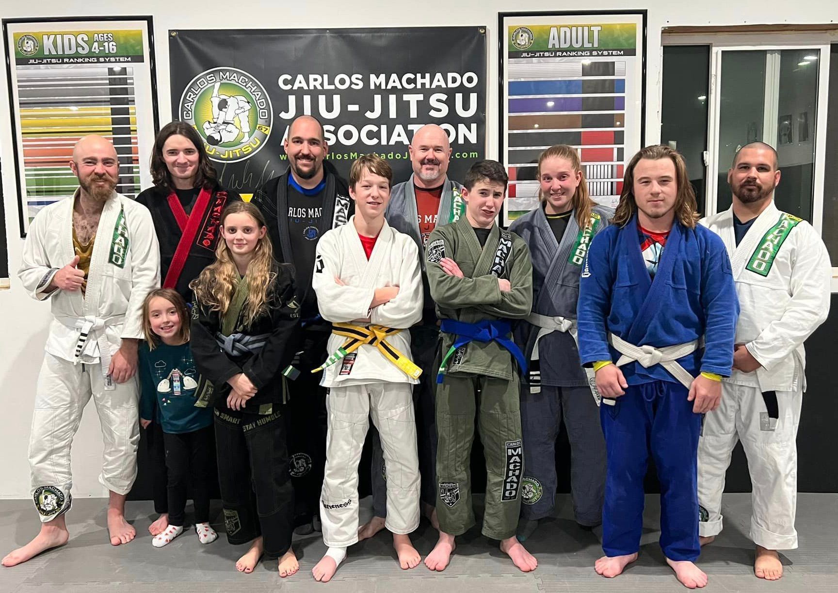 A group of people in karate uniforms are posing for a picture.