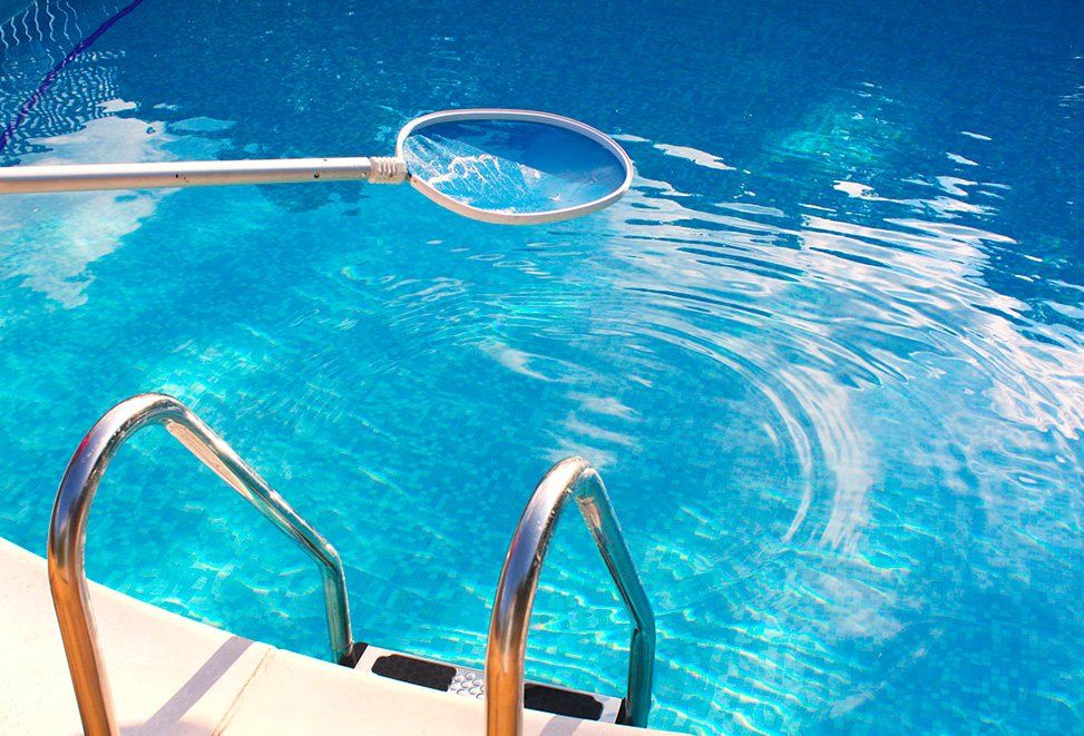 A swimming pool is being built in front of a house.