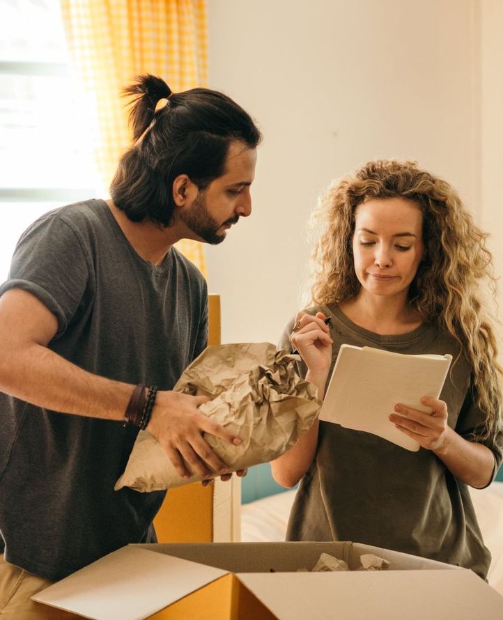 A man and a woman are moving into a new home.