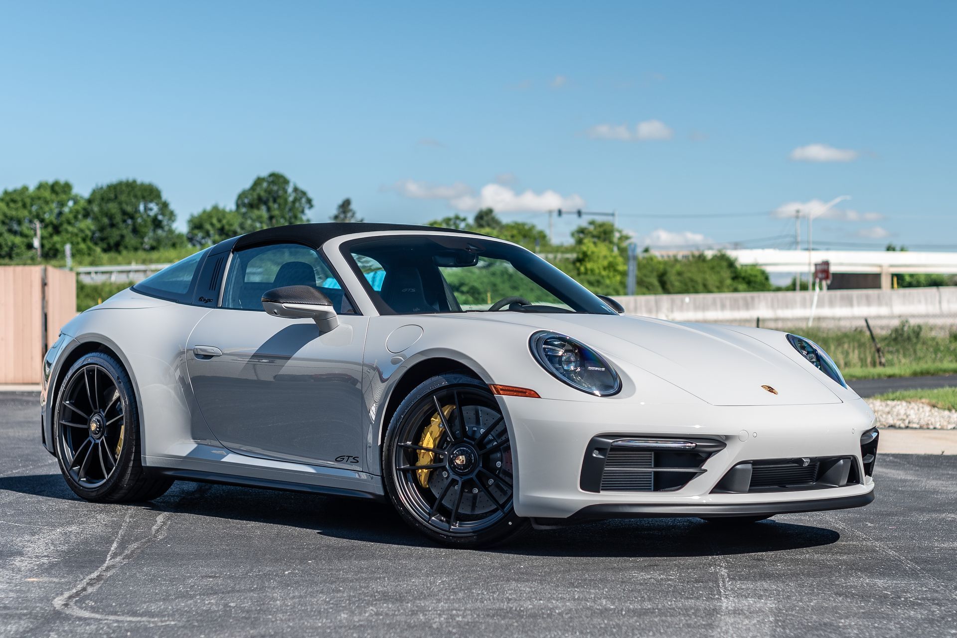 A silver porsche targa 4s is parked in a parking lot.