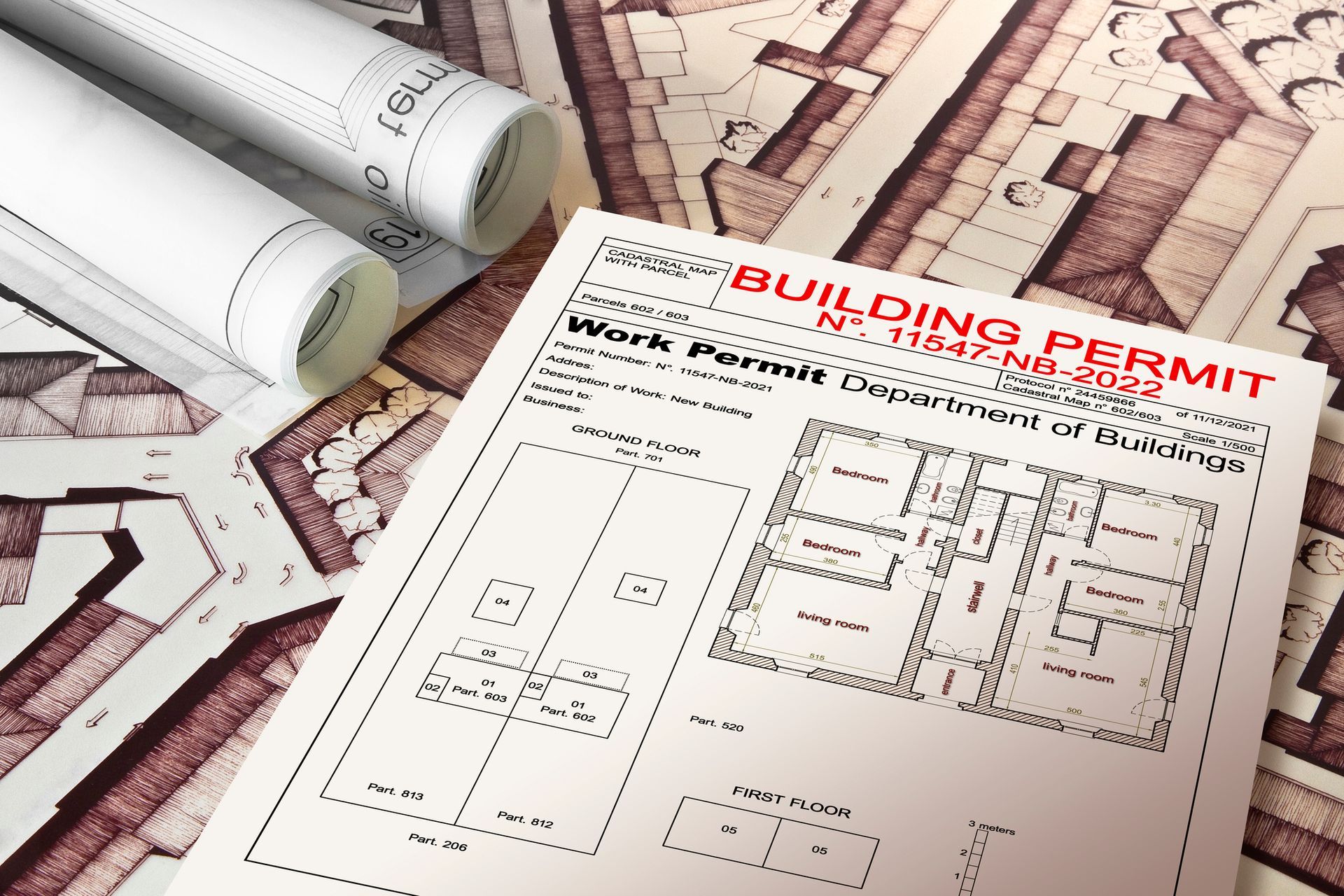 Building plans with rolled blueprints, a building permit, and a map.