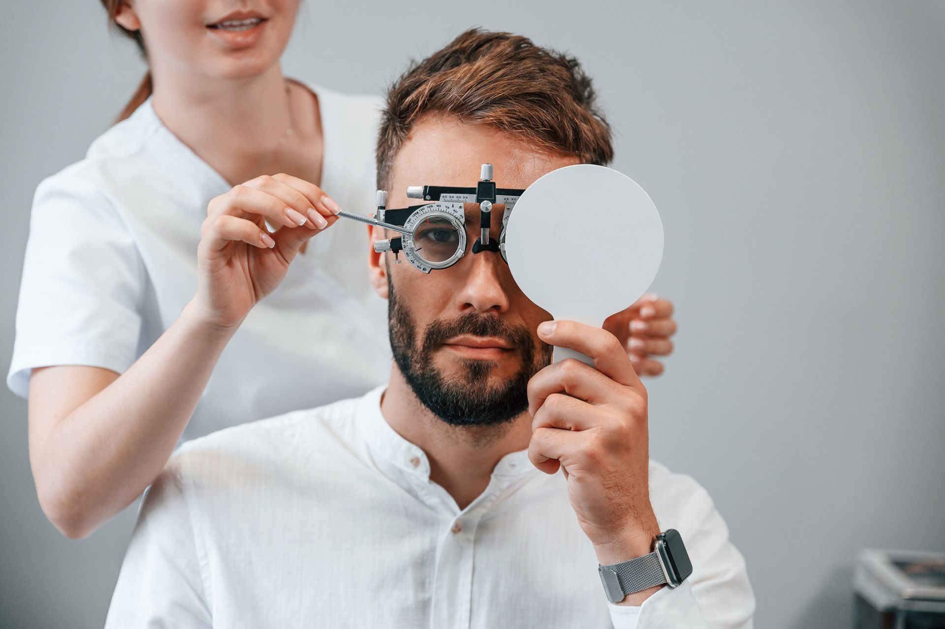 A man is getting his eyes checked by an ophthalmologist. A man is getting his eyes checked by an ophthalmologist.