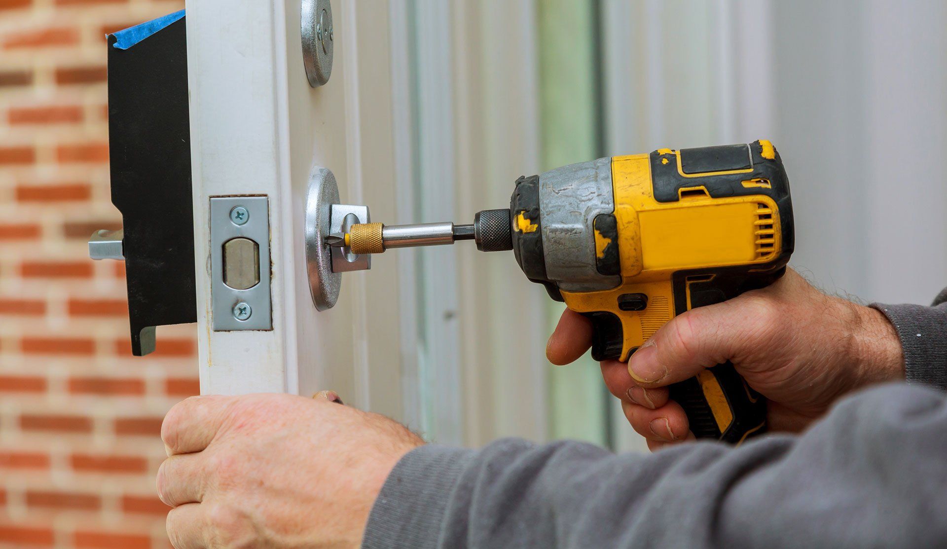 locksmith using lockpick tools to open wood door in emergency time