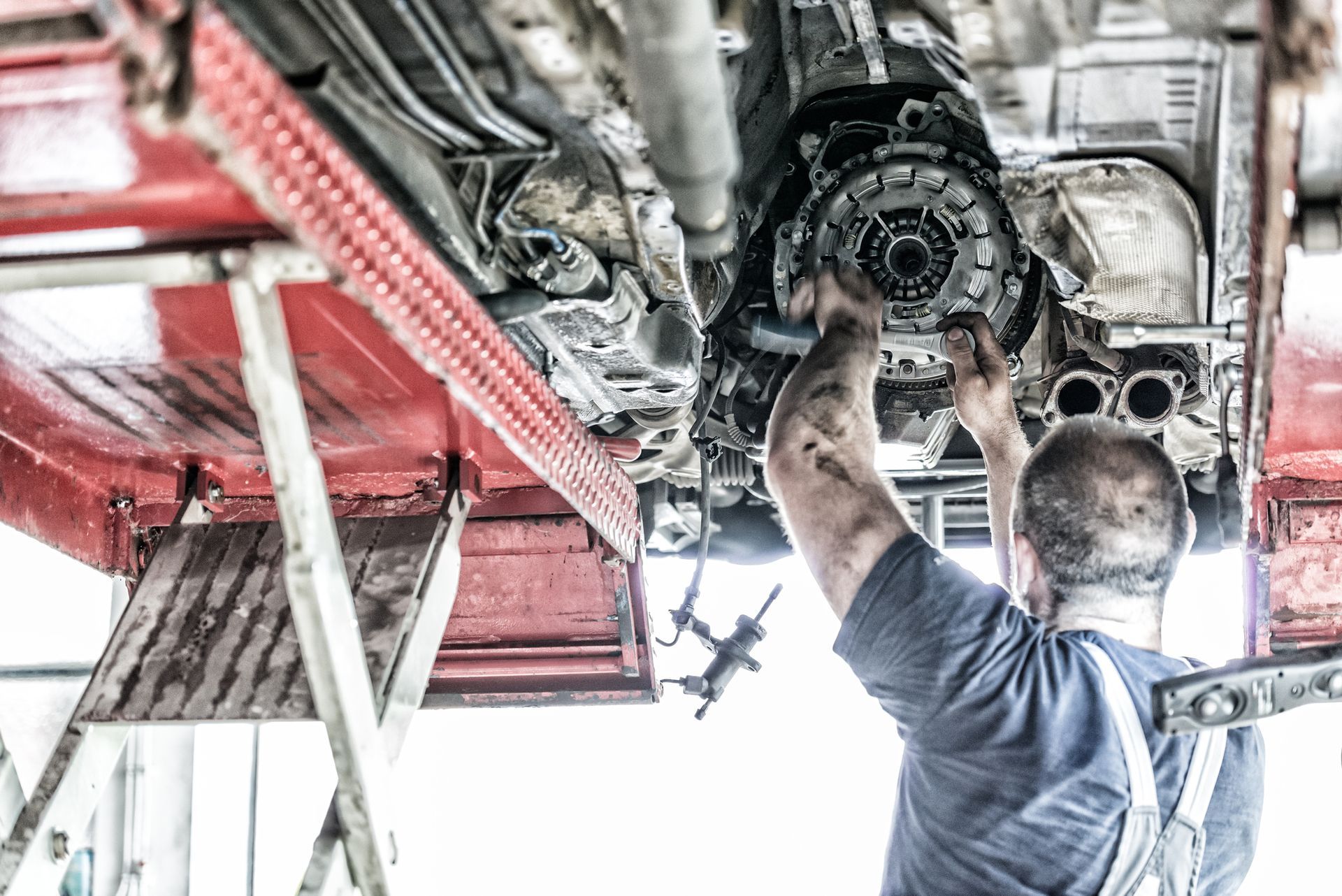 Auto mechanic working on car with emphasis on auto transmission repair | Fairhope, AL
