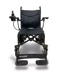 A black electric wheelchair with a motor attached to the arm rests on a white background.