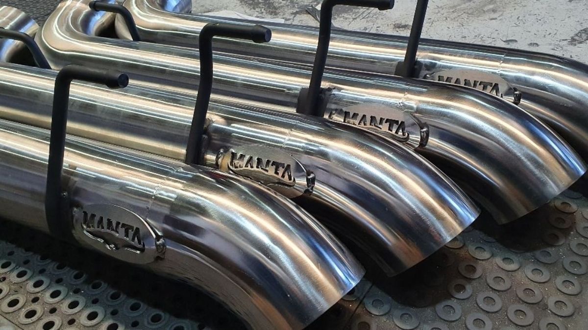 A bunch of Manta Exhausts are sitting on top of each other on a table.