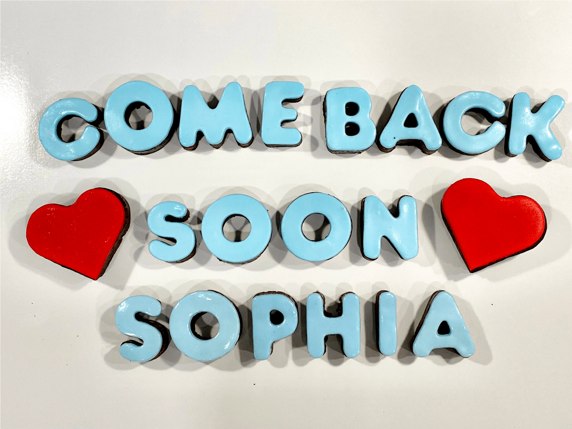 A sign that says come back soon sophia on it