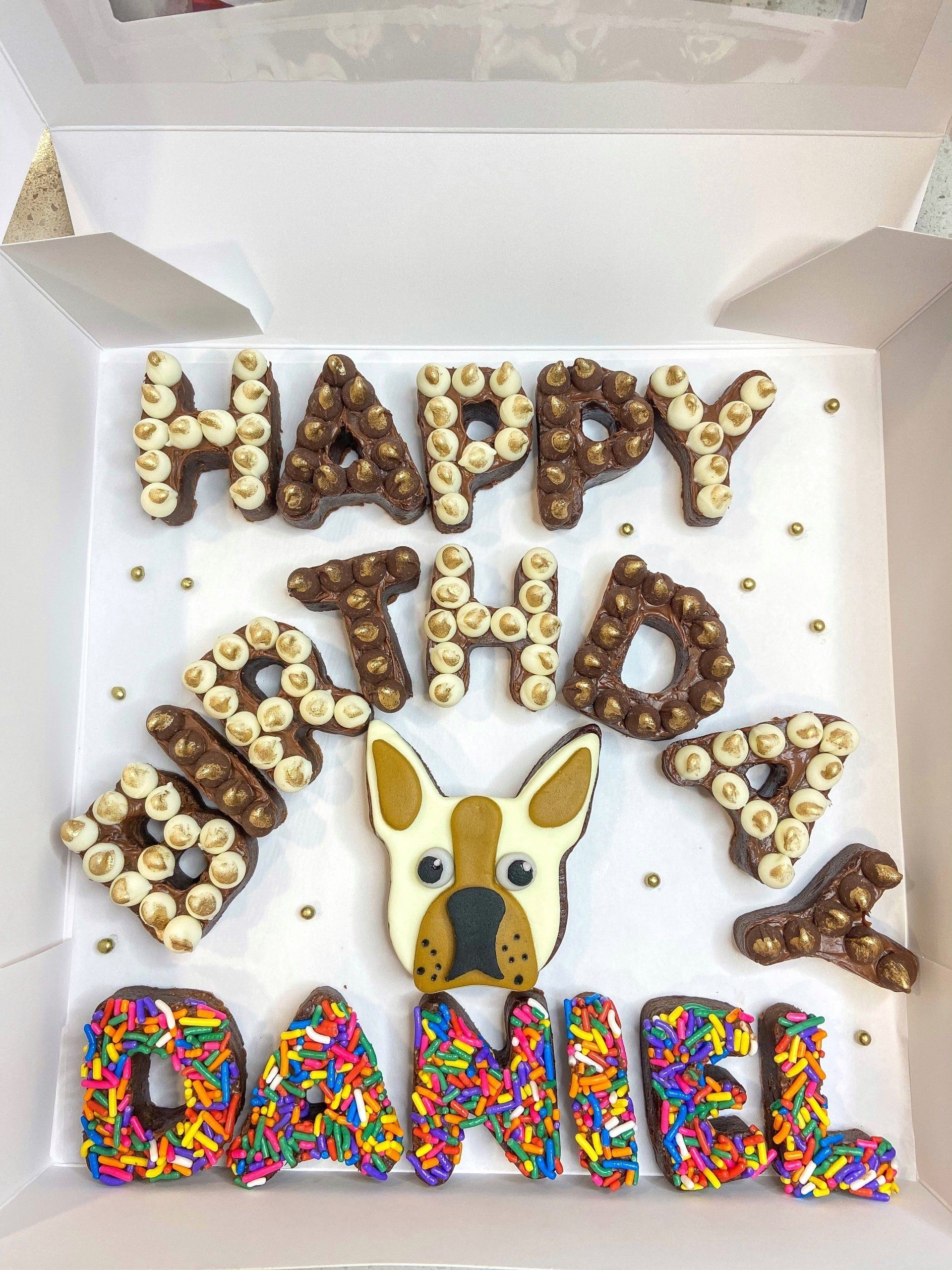 A box filled with chocolate letters that say happy birthday daniel