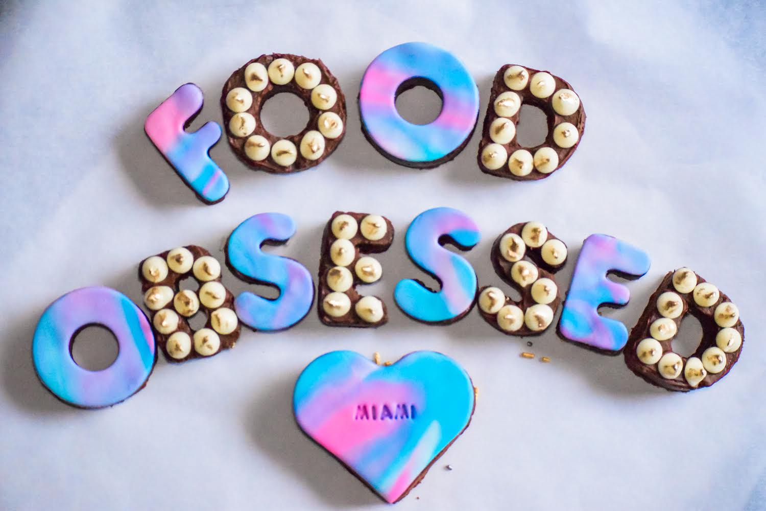 The word food obsessed is written on a white surface