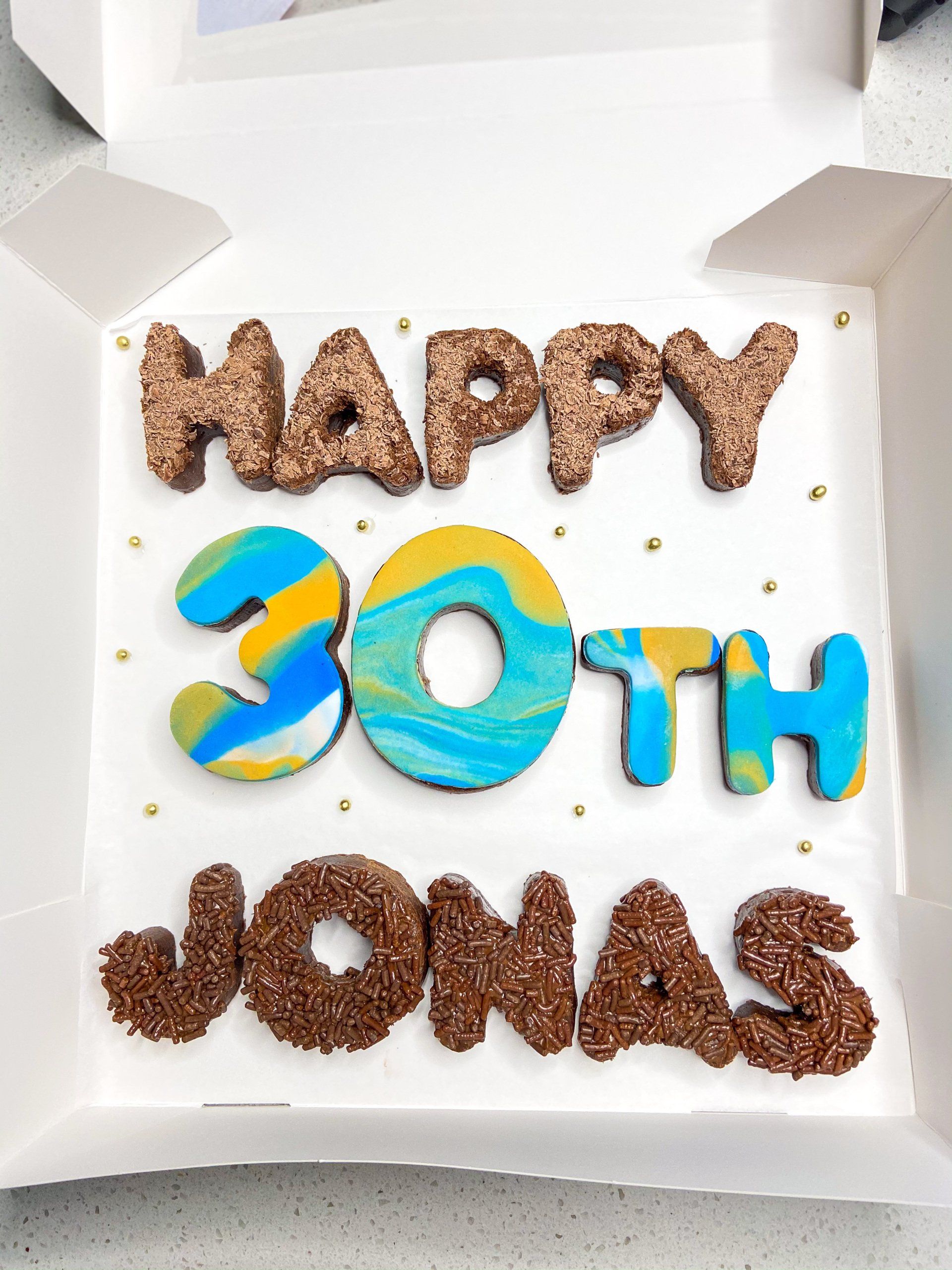 A cake that says happy 30th jonas on it