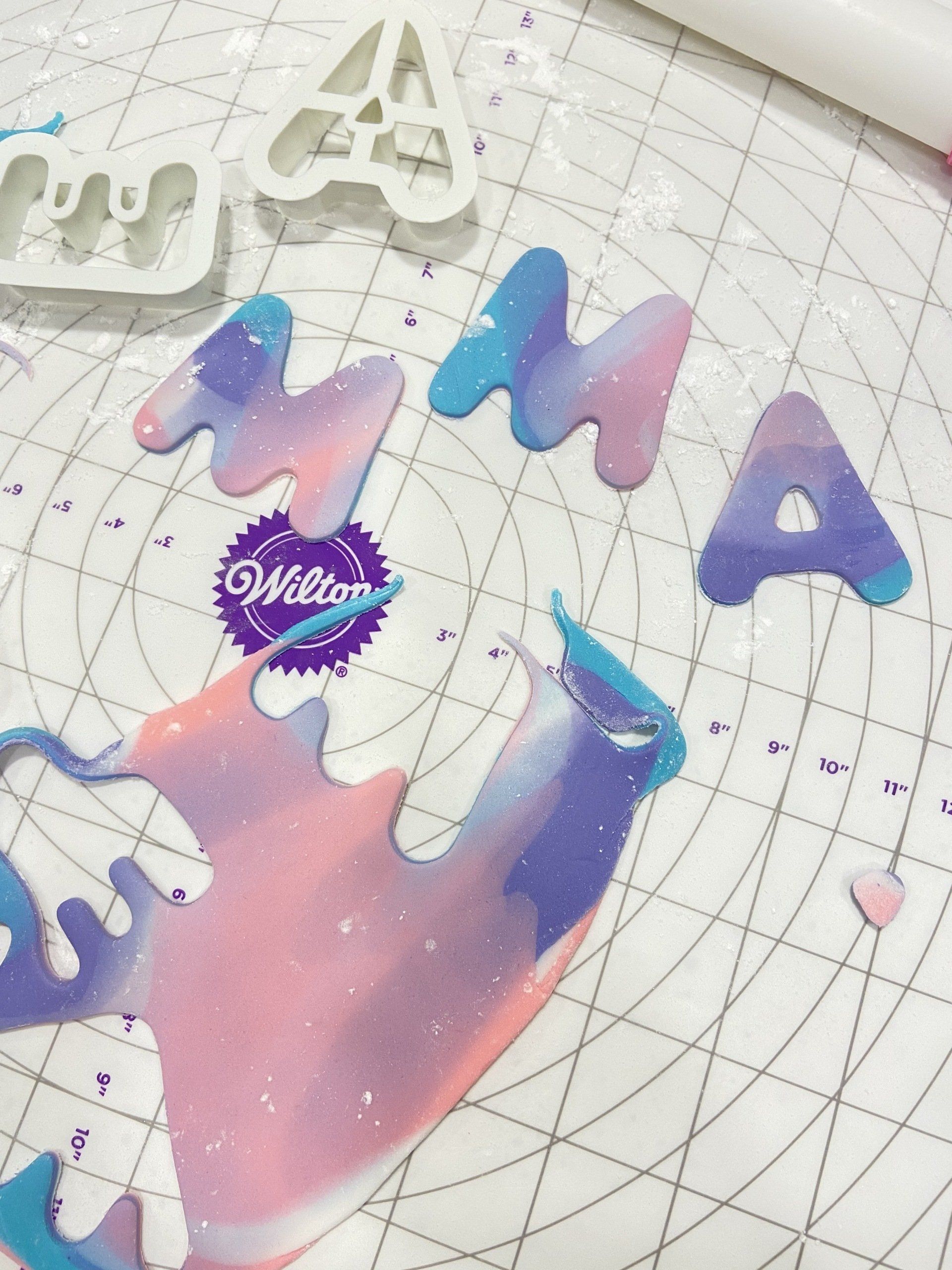 A wilton cookie cutter sits on a cutting mat