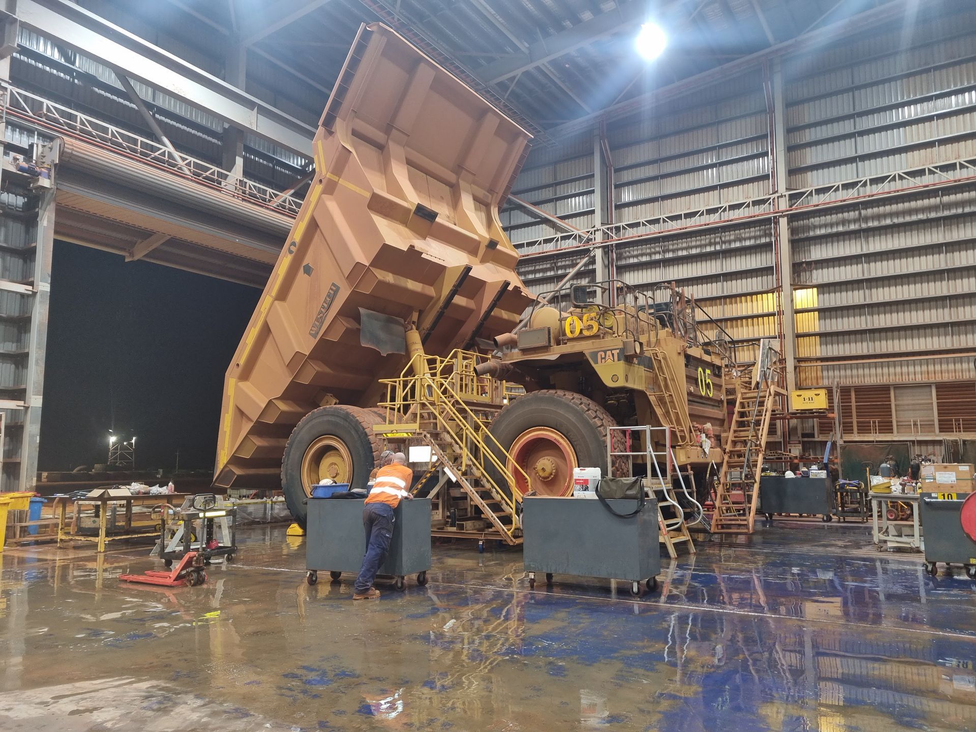 A Yellow Excavator is Sitting in the Middle of a Dirt Field — Blue Diesel & Equipment In Weipa, QLD