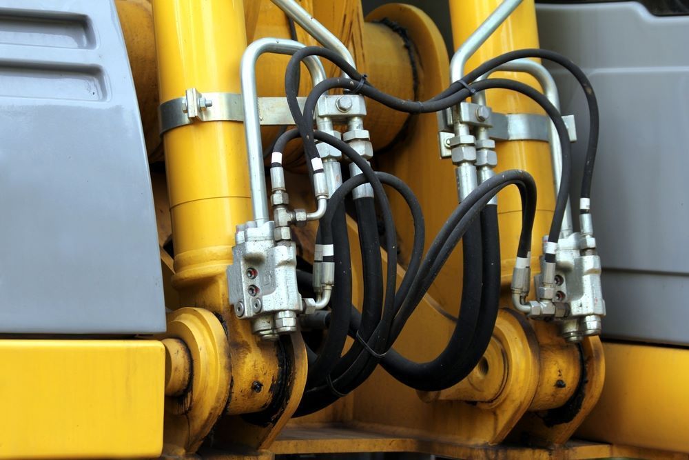 A Close Up of Hydraulic Cylinders on a Yellow Construction Vehicle — Blue Diesel & Equipment In Speewah, QLD