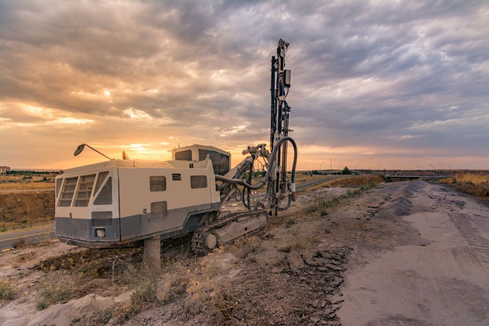 A Large Machine Is Sitting On The Side Of A Dirt Road — Blue Diesel & Equipment In Speewah, QLD