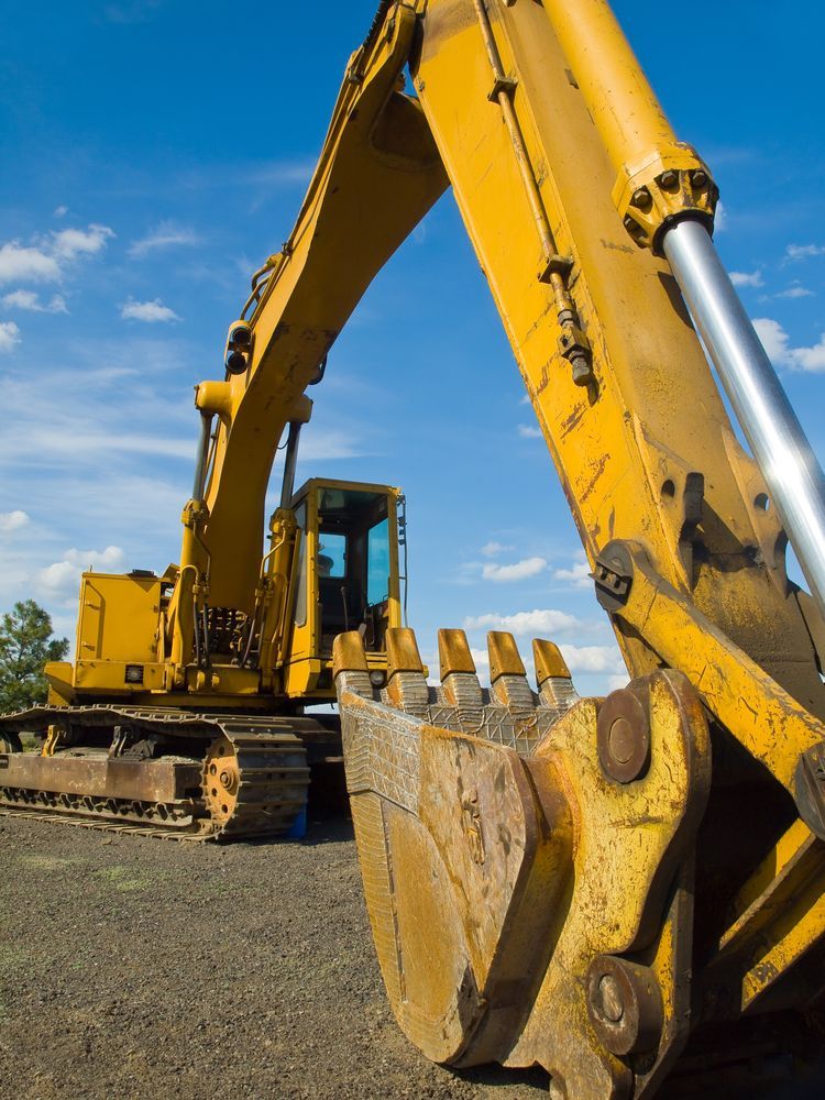 A Yellow Excavator Is Parked On A Dirt Road — Blue Diesel & Equipment In Speewah, QLD