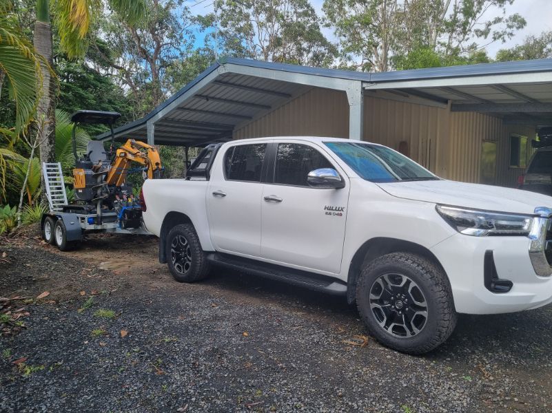 A White Truck With A Trailer Attached To It Is Parked In Front Of A Building — Blue Diesel & Equipment In Speewah, QLD