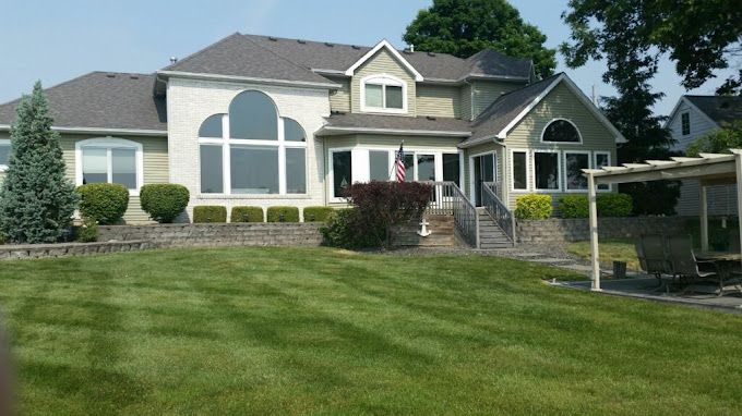 A large house with a large lawn in front of it