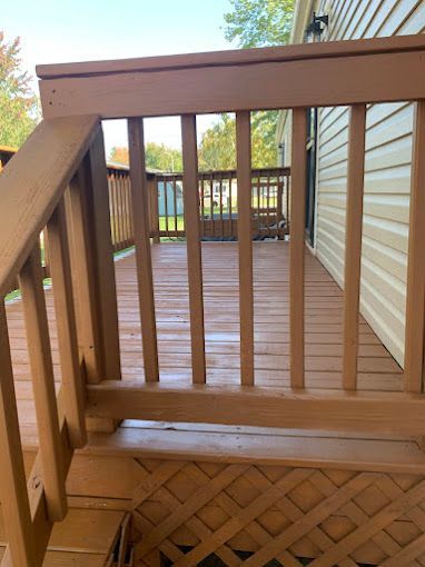 A wooden deck with stairs leading up to it