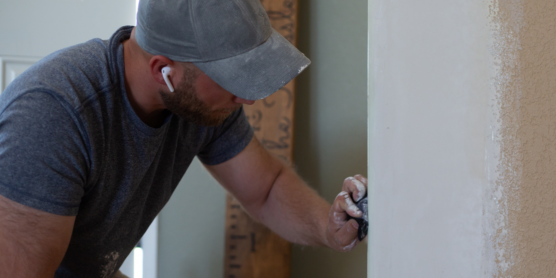 A person is plastering a wall with a spatula.